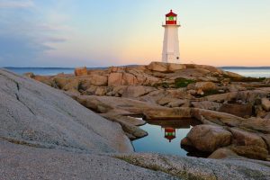 Lighthouse reflected in a pool of water